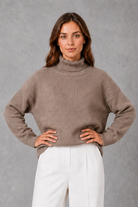 Women’s high neck knit jumper with a relaxed loose fit, cosy turtleneck, long sleeves and soft knitted finish for autumn and winter.