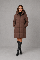 Women’s hooded puffer coat with lightweight insulated padding, structured hood and a flattering feminine silhouette for cold-weather wear.