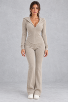 Women’s hooded ribbed knit co-ord set with a fitted zip-up top, long sleeves and matching flared trousers.
