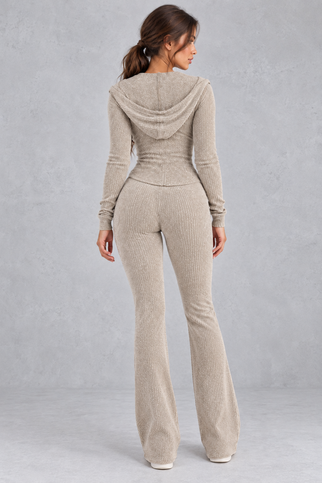 Women’s hooded ribbed knit co-ord set with a fitted zip-up top, long sleeves and matching flared trousers.