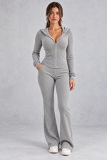 Women’s hooded ribbed knit co-ord set with a fitted zip-up top, long sleeves and matching flared trousers.