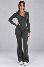 Women’s hooded ribbed knit co-ord set with a fitted zip-up top, long sleeves and matching flared trousers.