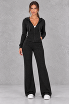 Women’s ribbed knit two-piece co-ord set with a fitted hooded zip-up top, adjustable drawstrings and matching wide leg trousers.