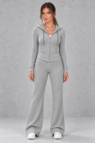 Women’s ribbed knit two-piece co-ord set with a fitted hooded zip-up top, adjustable drawstrings and matching wide leg trousers.