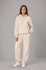 Women’s casual two piece tracksuit with relaxed drawstring hoodie and matching tapered cuffed joggers.