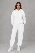 Women’s casual two piece tracksuit with relaxed drawstring hoodie and matching tapered cuffed joggers.