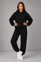 Women’s casual two piece tracksuit with relaxed drawstring hoodie and matching tapered cuffed joggers.
