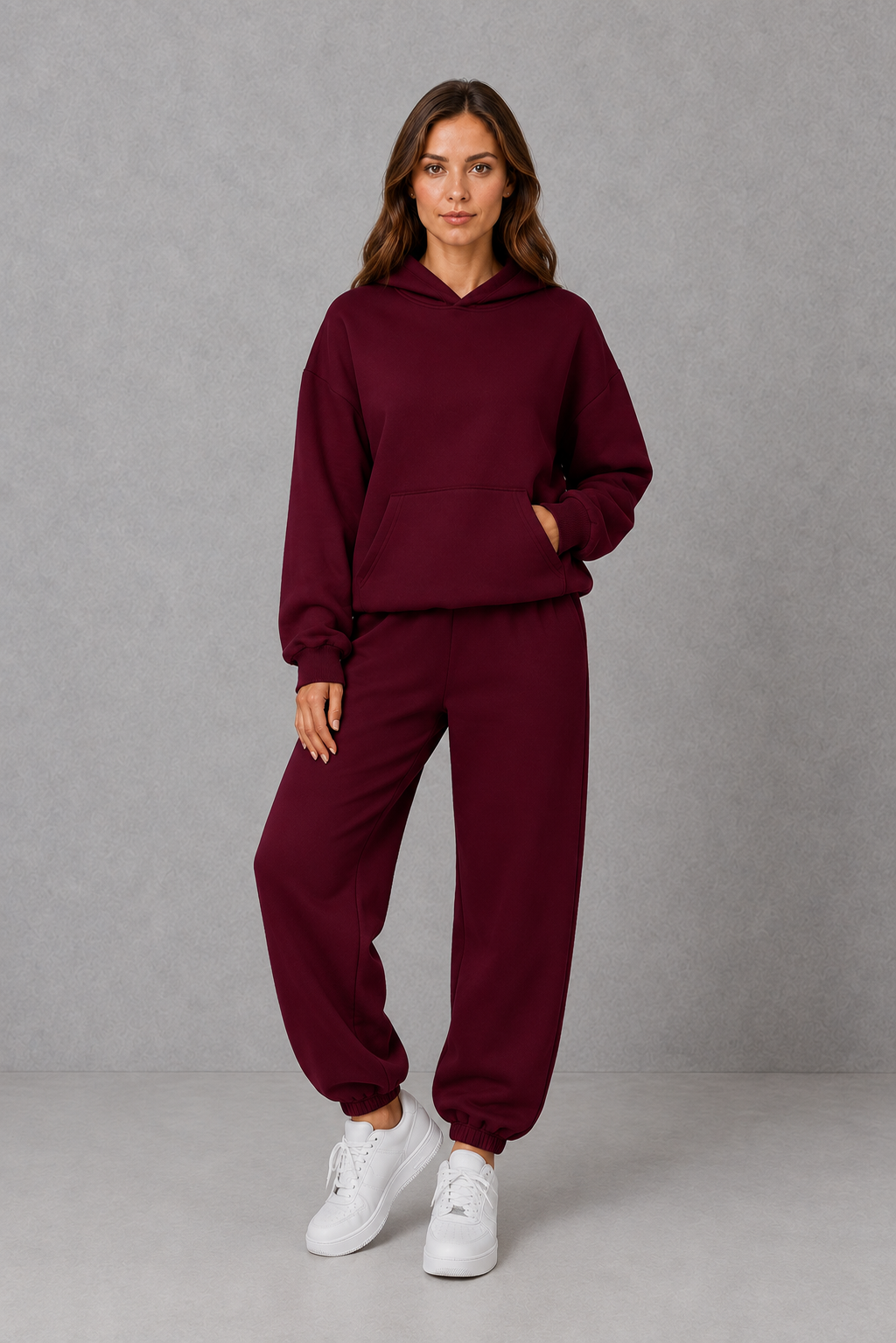 Women’s casual two piece tracksuit with relaxed drawstring hoodie and matching tapered cuffed joggers.