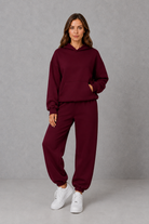 Women’s casual two piece tracksuit with relaxed drawstring hoodie and matching tapered cuffed joggers.