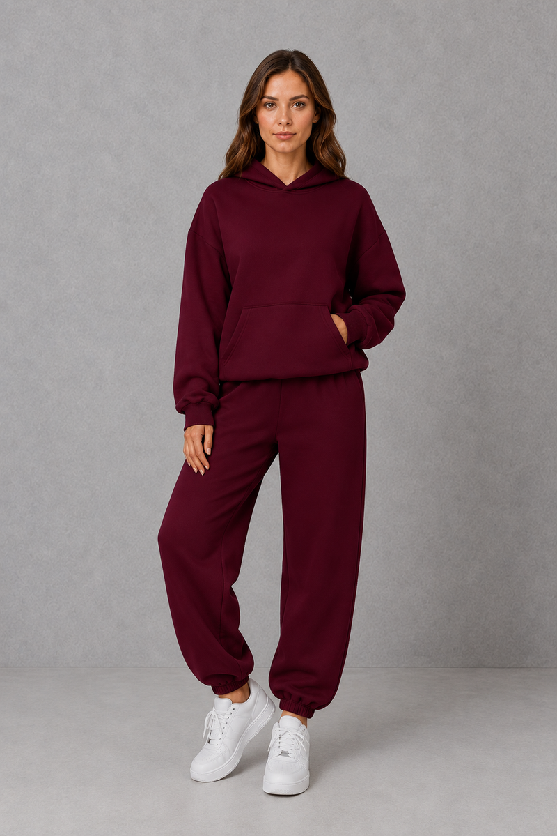 Women’s casual two piece tracksuit with relaxed drawstring hoodie and matching tapered cuffed joggers.