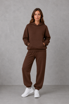 Women’s casual two piece tracksuit with relaxed drawstring hoodie and matching tapered cuffed joggers.