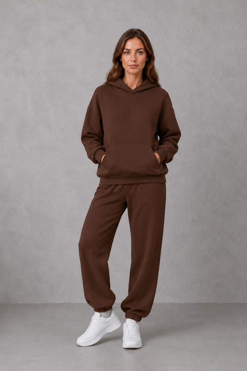 Women’s casual two piece tracksuit with relaxed drawstring hoodie and matching tapered cuffed joggers.