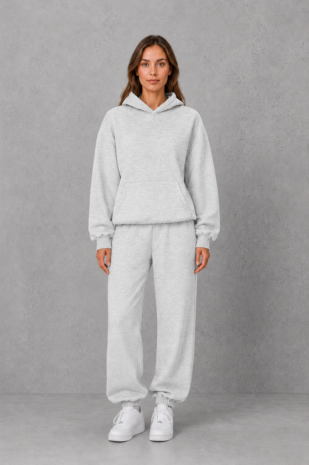 Women’s casual two piece tracksuit with relaxed drawstring hoodie and matching tapered cuffed joggers.