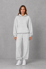 Women’s casual two piece tracksuit with relaxed drawstring hoodie and matching tapered cuffed joggers.