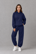 Women’s casual two piece tracksuit with relaxed drawstring hoodie and matching tapered cuffed joggers.