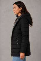 Women’s hooded long winter coat with a warm plush lining, softly tapered silhouette and elegant structured finish for cold-weather styling.