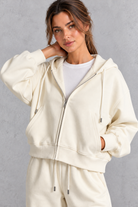 Women's cream zip-up hoodie – close-up of zip and drawstring hood