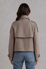 Women’s houndstooth button jacket with high neck and structured woven design.