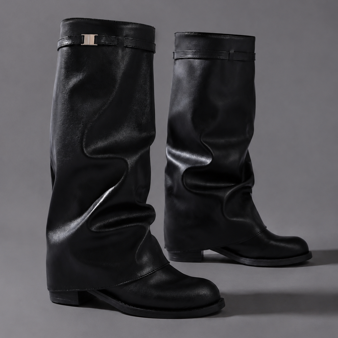 Women’s knee-high slouch boots with pointed toe, low block heel and metal cuff detail.