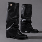 Women’s knee-high slouch boots with pointed toe, low block heel and metal cuff detail.