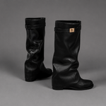 Women’s knee-high slouch boots with pointed toe, low block heel and metal cuff detail.
