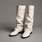 Women’s knee-high slouch boots with pointed toe, low block heel and metal cuff detail.