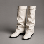 Women’s knee-high slouch boots with pointed toe, low block heel and metal cuff detail.