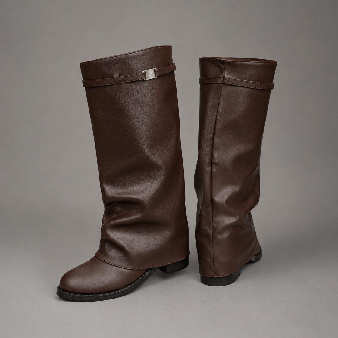 Women’s knee-high slouch boots with pointed toe, low block heel and metal cuff detail.