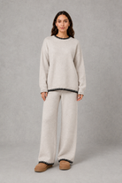 Women’s knitted co-ord set featuring a relaxed crew-neck jumper with contrast trim and matching wide leg knitted trousers.