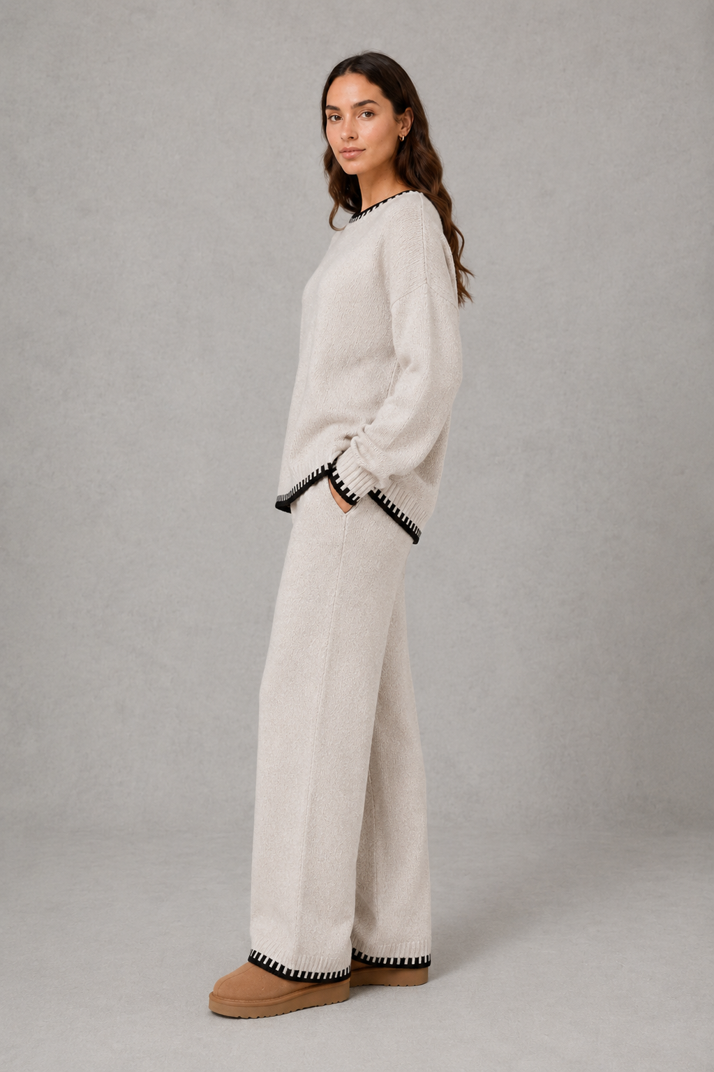 Women’s knitted co-ord set featuring a relaxed crew-neck jumper with contrast trim and matching wide leg knitted trousers.