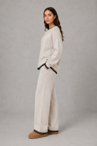 Women’s knitted co-ord set featuring a relaxed crew-neck jumper with contrast trim and matching wide leg knitted trousers.