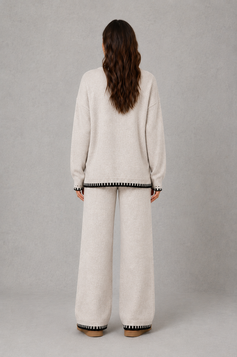Women’s knitted co-ord set featuring a relaxed crew-neck jumper with contrast trim and matching wide leg knitted trousers.