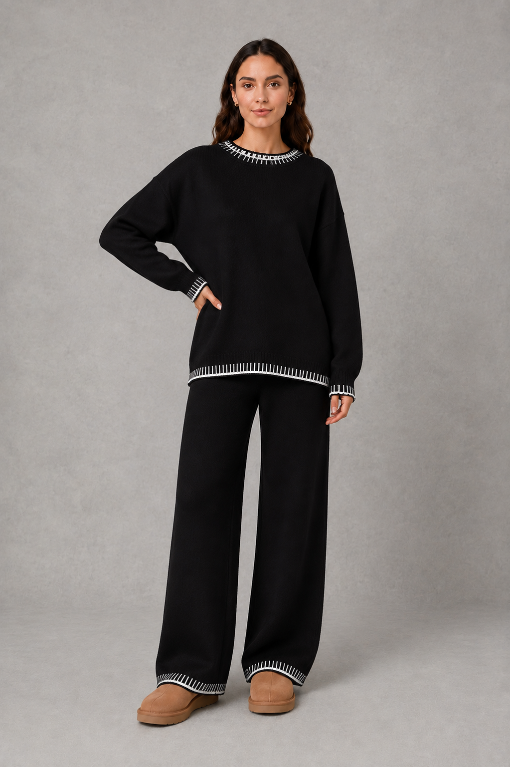 Women’s knitted co-ord set featuring a relaxed crew-neck jumper with contrast trim and matching wide leg knitted trousers.
