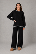 Women’s knitted co-ord set featuring a relaxed crew-neck jumper with contrast trim and matching wide leg knitted trousers.