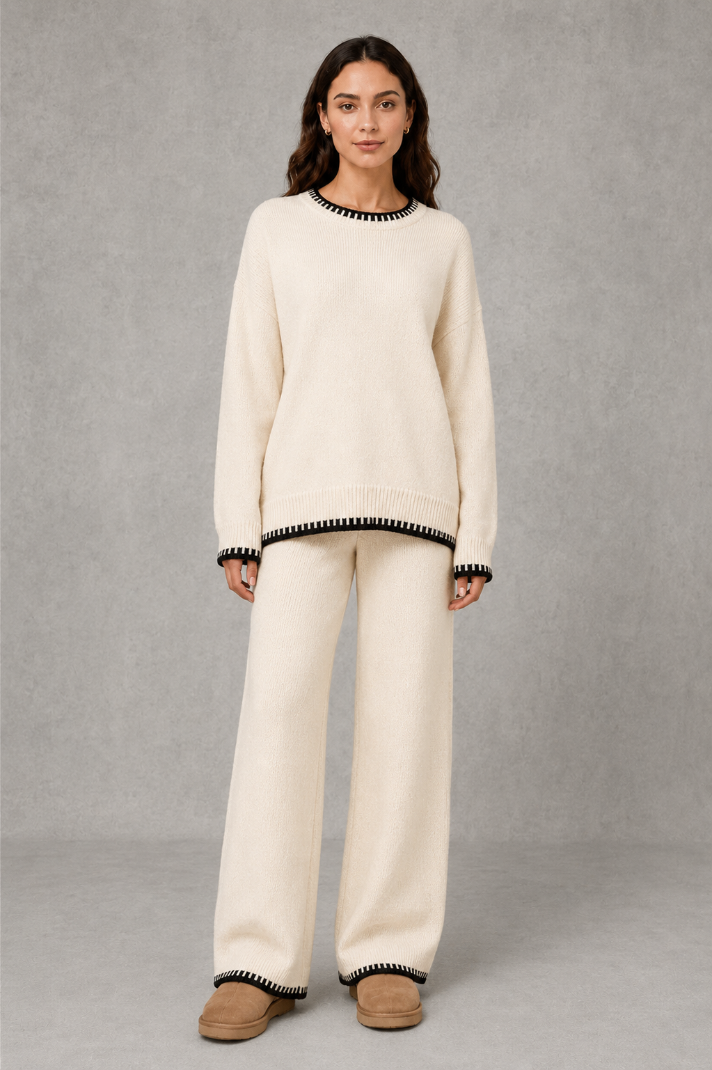 Women’s knitted co-ord set featuring a relaxed crew-neck jumper with contrast trim and matching wide leg knitted trousers.