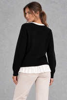 Women’s layered knit cardigan with a crew neckline, gold-tone button front, long sleeves and contrasting white pleated shirt-style hem.
