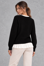 Women’s layered knit cardigan with a crew neckline, gold-tone button front, long sleeves and contrasting white pleated shirt-style hem.