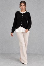 Women’s layered knit cardigan with a crew neckline, gold-tone button front, long sleeves and contrasting white pleated shirt-style hem.