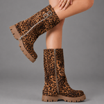 Women’s brown leather knee-high boots with double buckle details, long external zip and chunky sturdy sole.