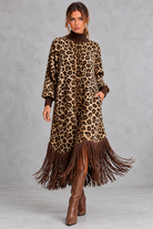 Women’s leopard print boho maxi dress with a high neckline, long sleeves, relaxed A-line silhouette, practical pockets and tassel-trimmed hem.