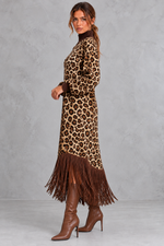Women’s leopard print boho maxi dress with a high neckline, long sleeves, relaxed A-line silhouette, practical pockets and tassel-trimmed hem.