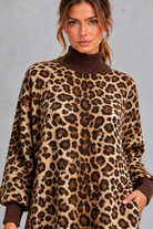 Women’s leopard print boho maxi dress with a high neckline, long sleeves, relaxed A-line silhouette, practical pockets and tassel-trimmed hem.