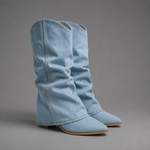 Women’s light blue denim knee-high boots with ruched shafts, pointed toes and square block heels.