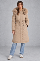 Women’s long hooded winter parka with faux fur trim, a plush-lined interior, adjustable drawstring waist and relaxed silhouette.