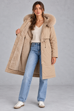 Women’s long hooded winter parka with faux fur trim, a plush-lined interior, adjustable drawstring waist and relaxed silhouette.