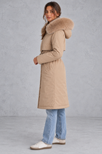 Women’s long hooded winter parka with faux fur trim, a plush-lined interior, adjustable drawstring waist and relaxed silhouette.