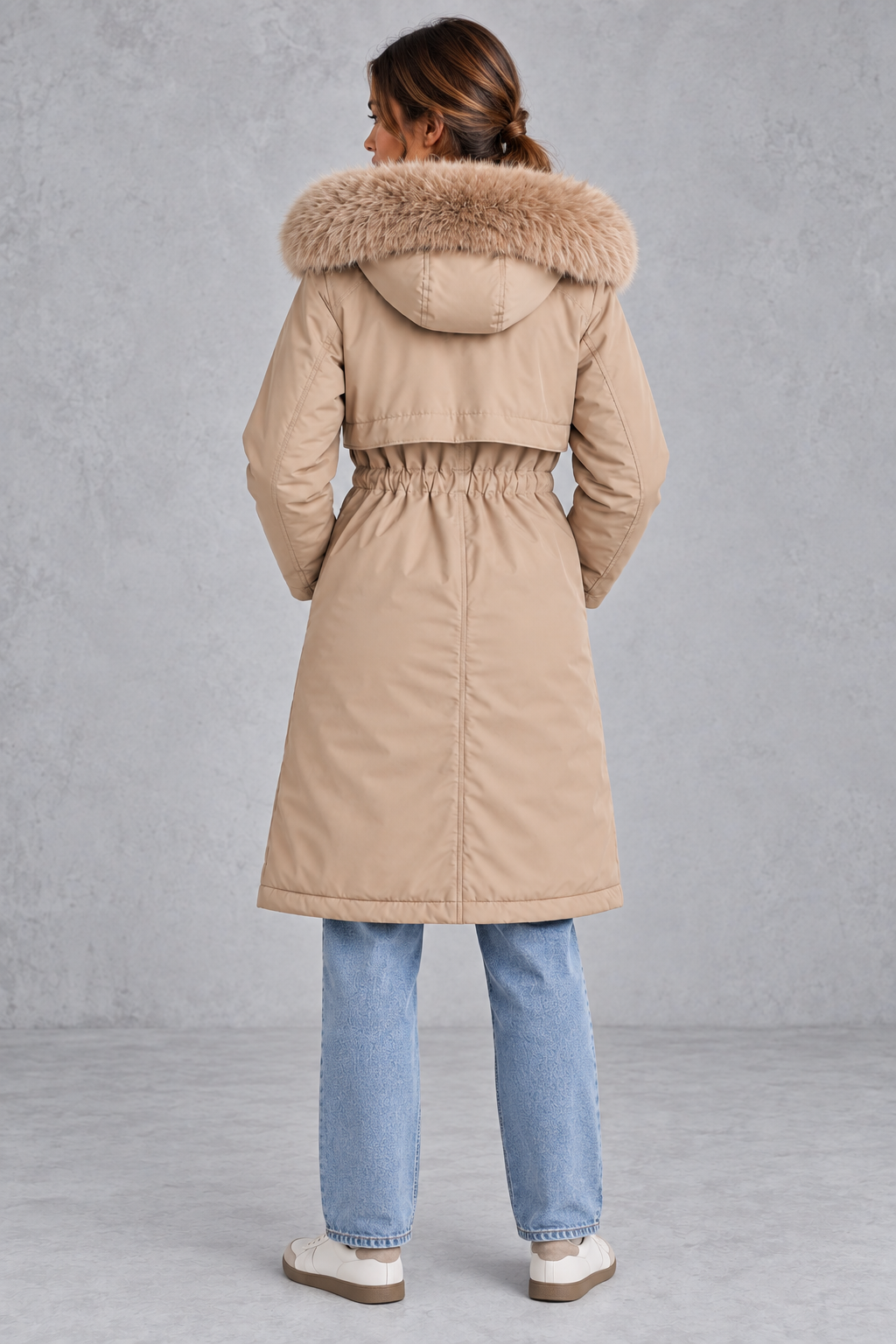 Women’s long hooded winter parka with faux fur trim, a plush-lined interior, adjustable drawstring waist and relaxed silhouette.