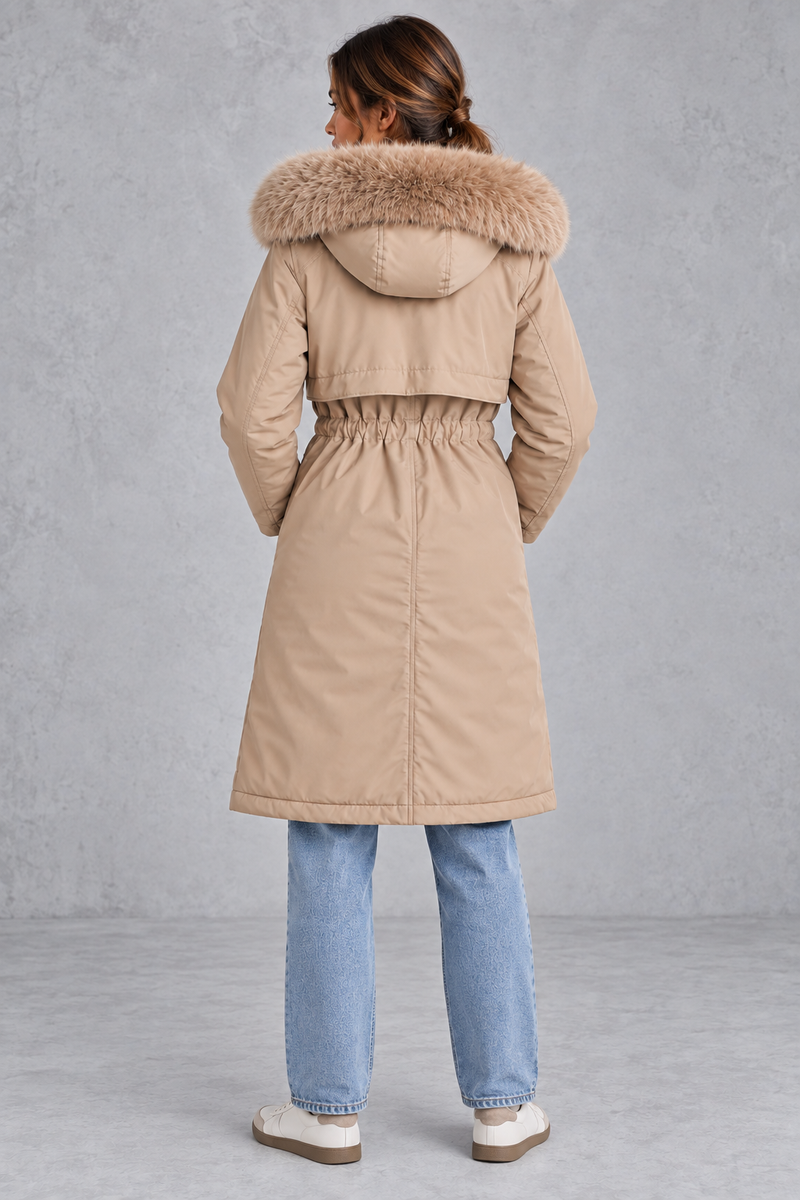 Women’s long hooded winter parka with faux fur trim, a plush-lined interior, adjustable drawstring waist and relaxed silhouette.