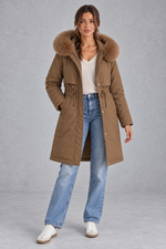 Women’s long hooded winter parka with faux fur trim, a plush-lined interior, adjustable drawstring waist and relaxed silhouette.