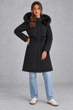 Women’s long hooded winter parka with faux fur trim, a plush-lined interior, adjustable drawstring waist and relaxed silhouette.